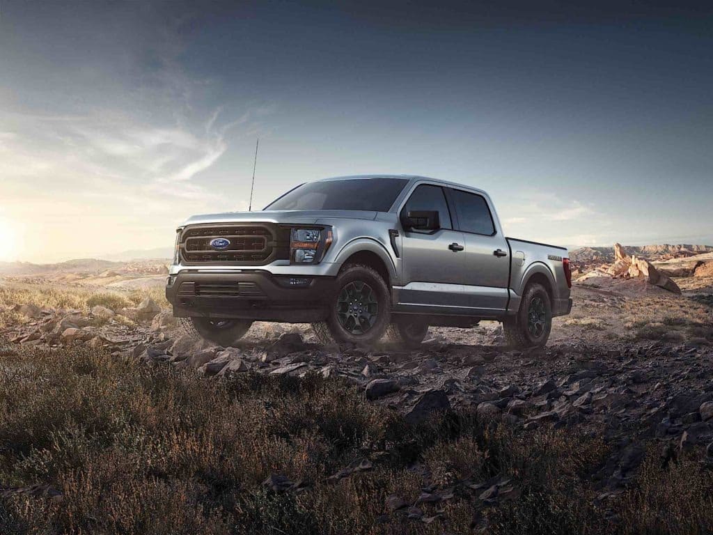 Ford's all-new 2023 F-150 Rattler on a rocky, grassy off-road environment.