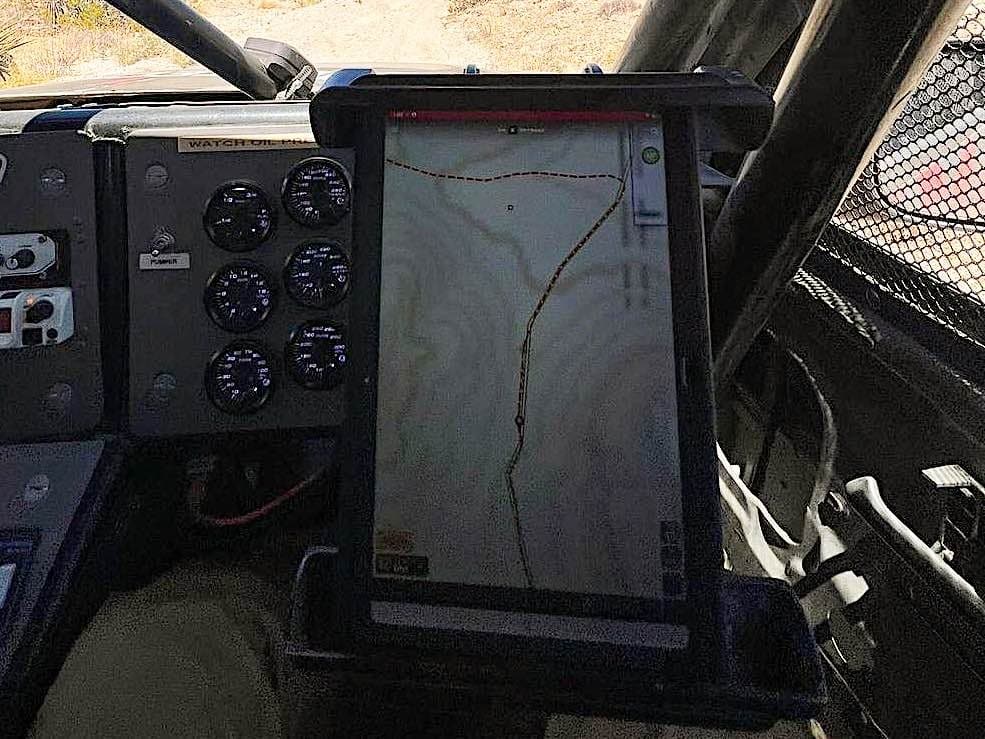 View of the desert from the cab of a racing truck.
