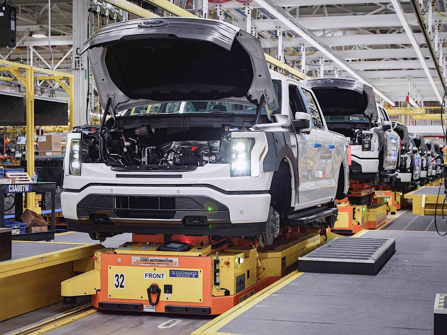 A line of Ford F-150 trucks on an assembly line.