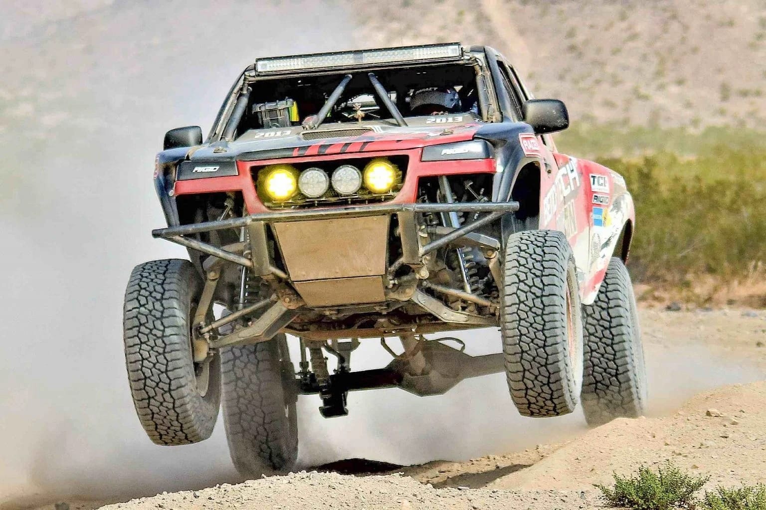 An off-road truck racing through the desert.