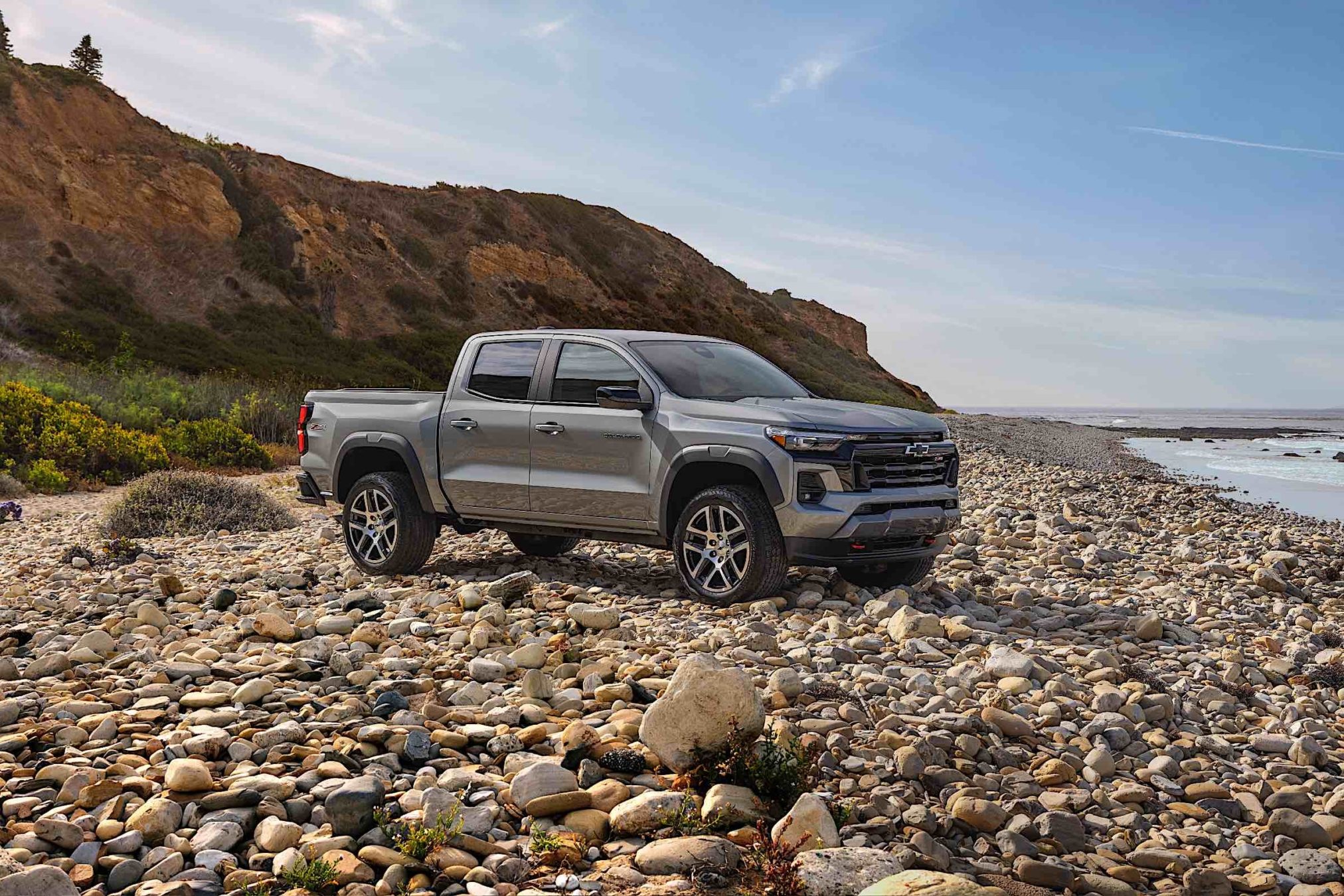 A 2023 Chevrolet Colorado driving down a dirty and rocky terrain.