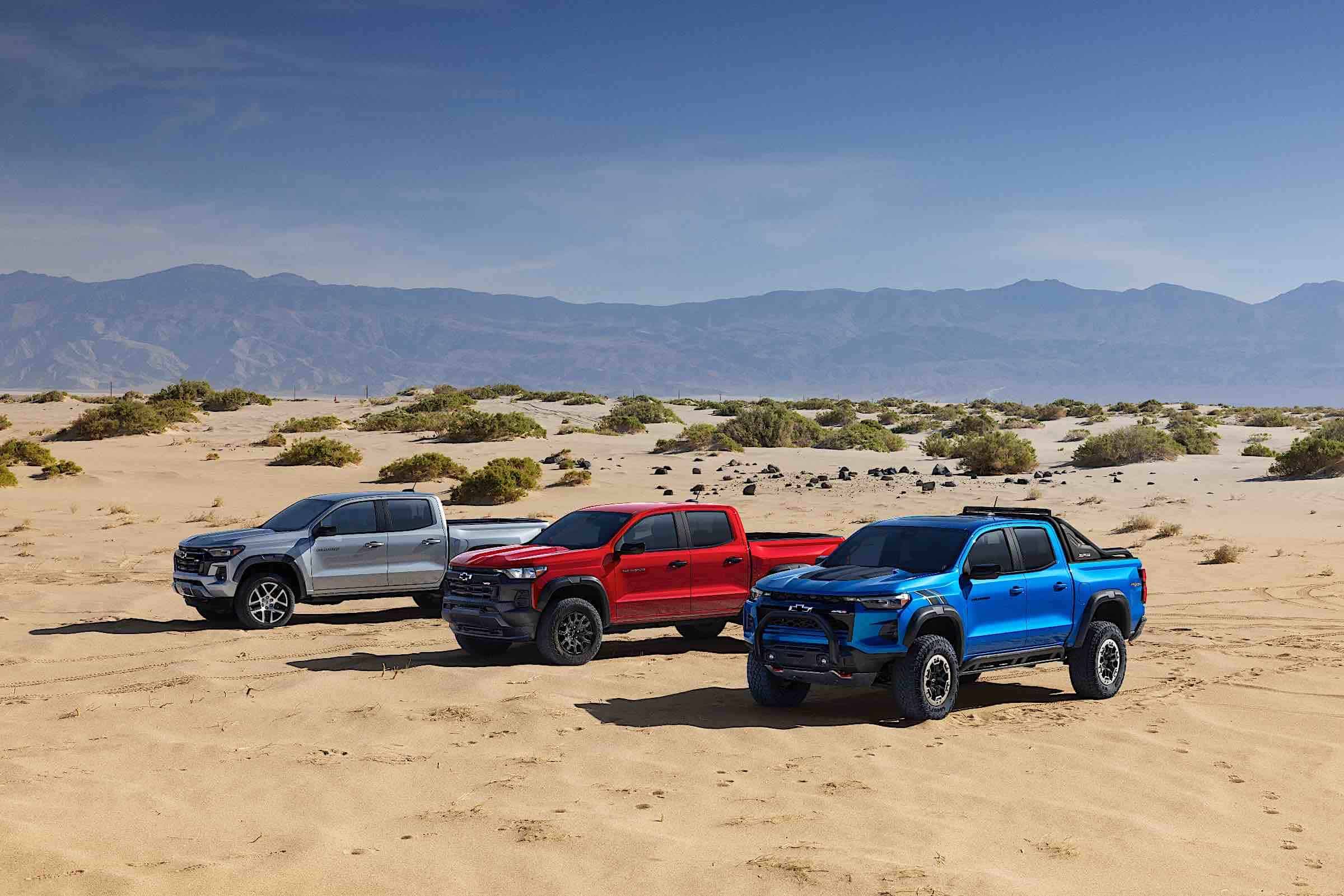 Three 2023 Chevrolet Colorado parked in the desert.