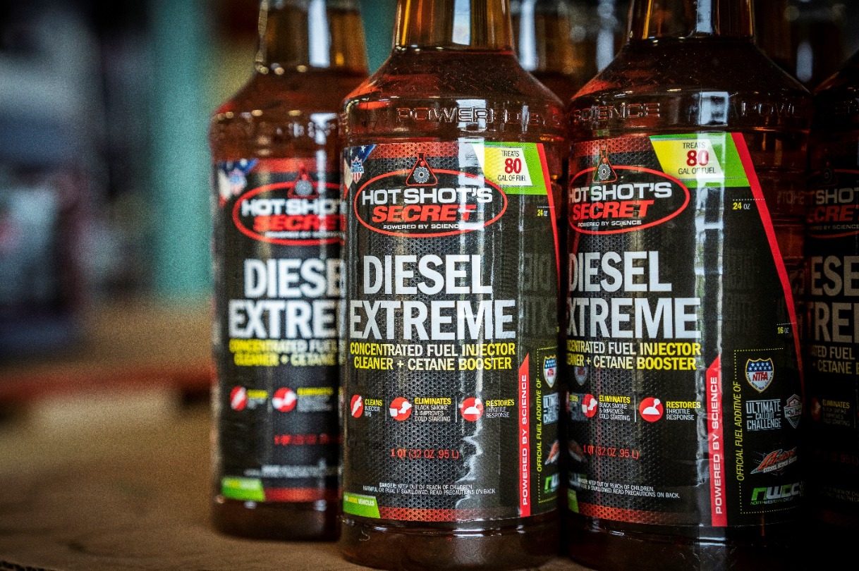 Three bottles of diesel engine injector fluid.